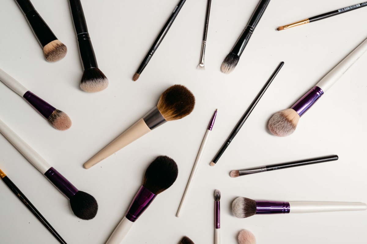Macro shot of professional makeup brushes with soft bristles and fine powder dust.