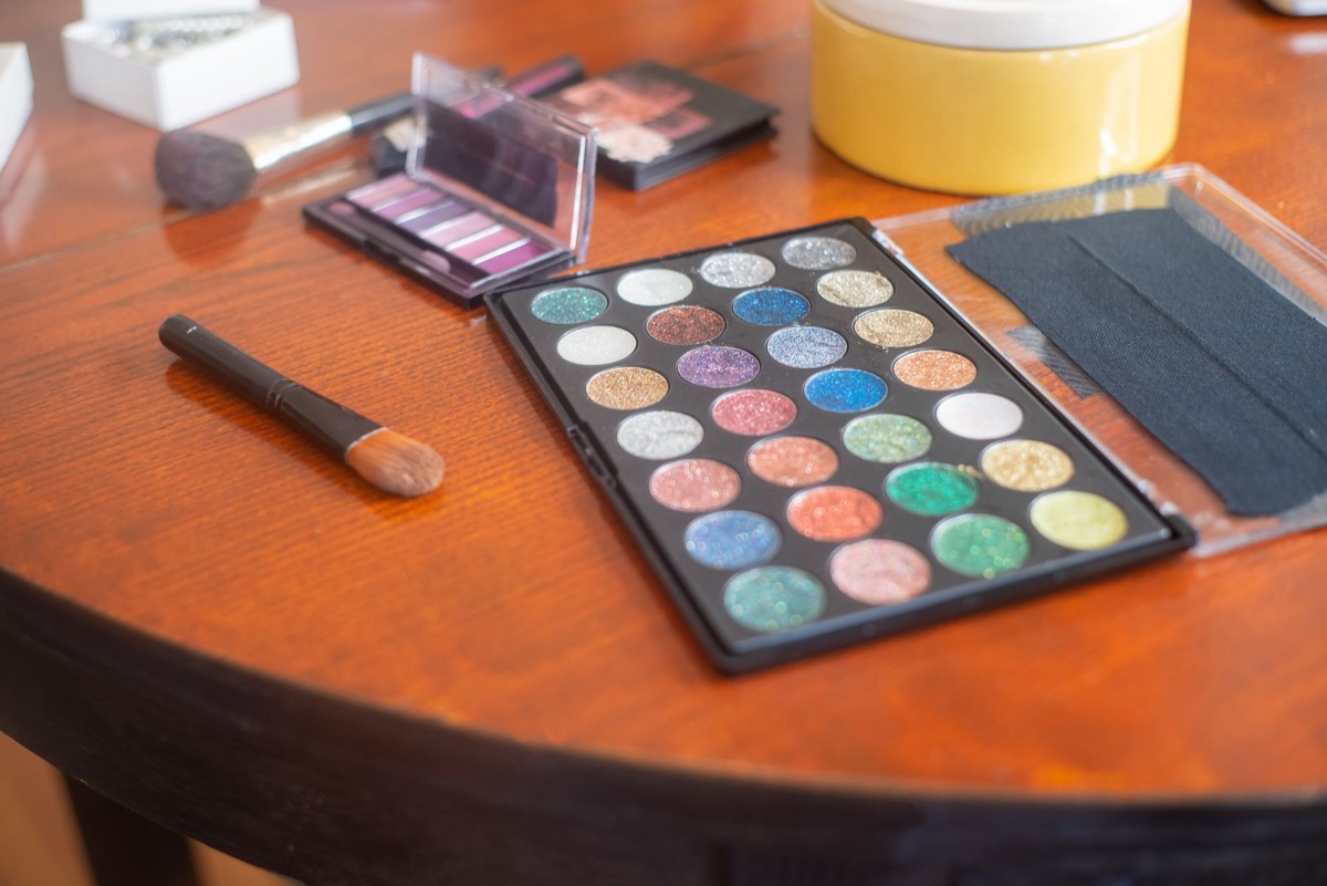 Pinceaux de maquillage et palettes d'ombres à paupières.