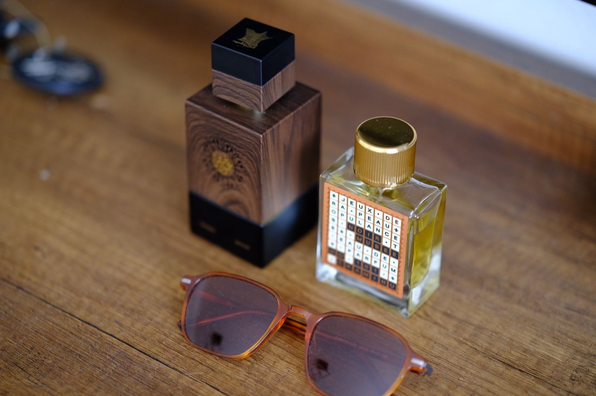A single, elegantly shaped perfume bottle catching warm light